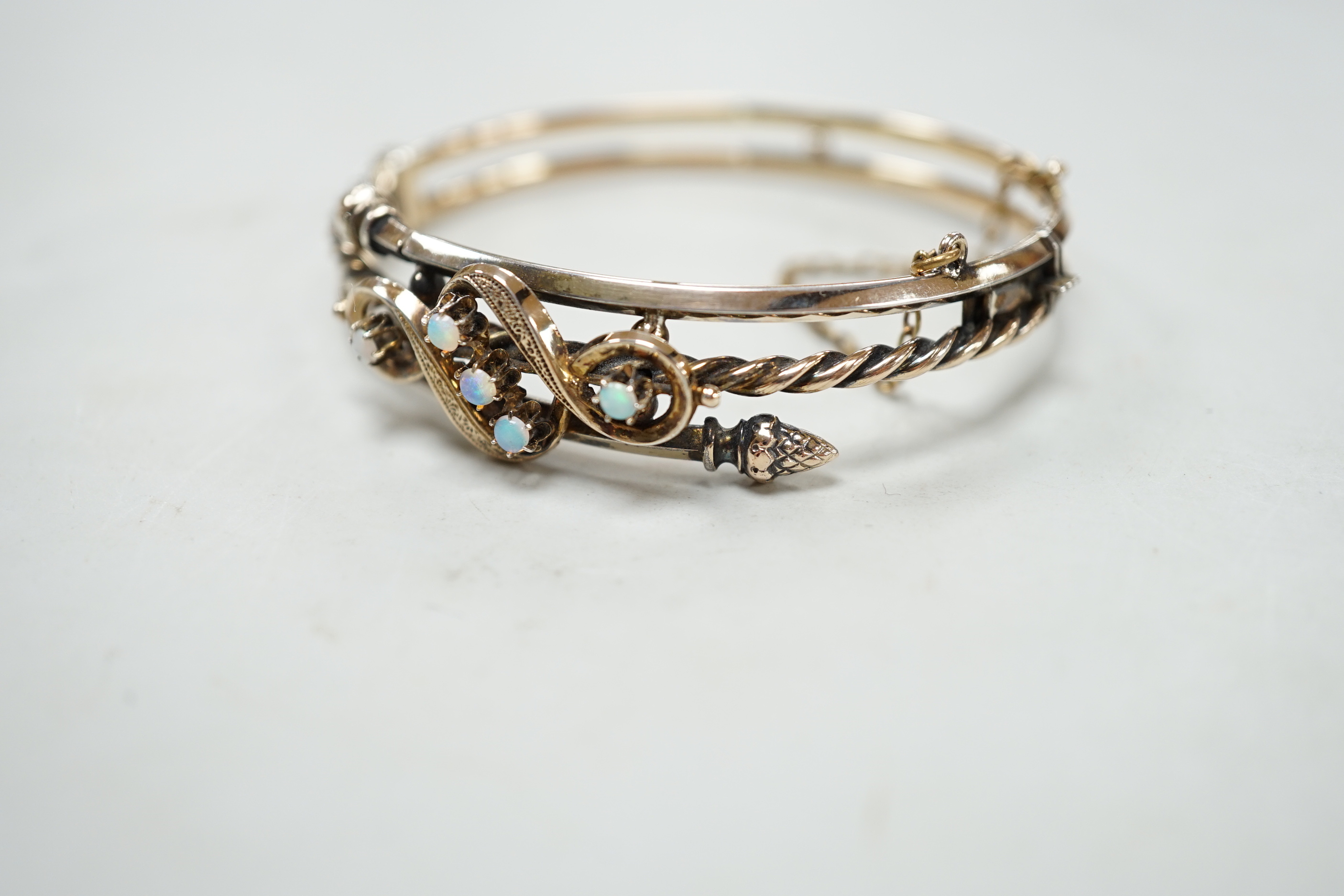 A late 19th/early 20th century Austro-Hungarian yellow metal and white opal cluster set hinged bangle, in original fitted box, together with a matching brooch(stone missing), 50mm